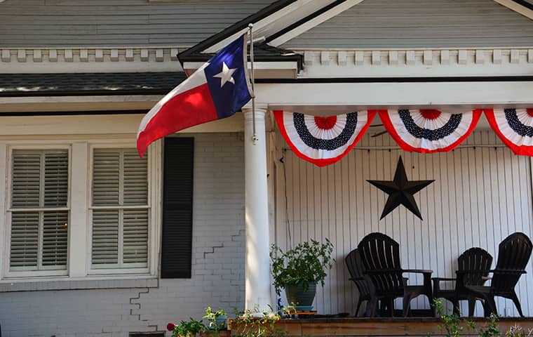 porch with american and texas banners